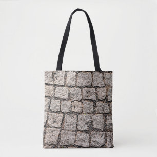Old cobble stone pattern at the streetabstract,anc tote bag