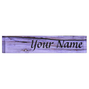 Old cracked purple paint on wood nameplate