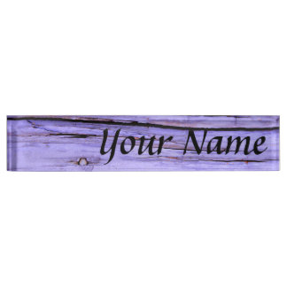 Old cracked purple paint on wood nameplate
