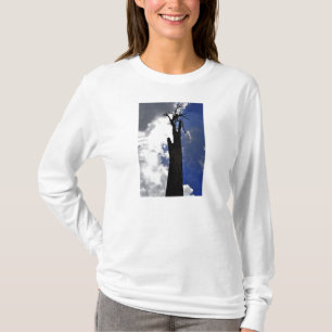 Old dead tree against dark cloudy sky T-Shirt