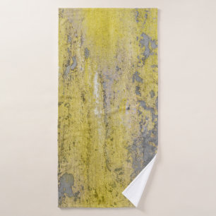 Old gray concrete wall with peeling yellow paint.  bath towel