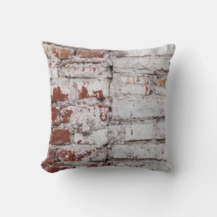 Old painted brick wall with peeling white paintwal cushion