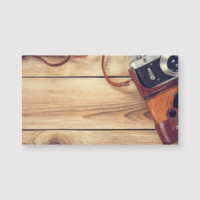 Old Retro Camera On Wooden Table Background (Front)