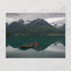 Old rowboat with mountains postcard