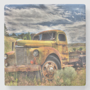 Old truck abandoned in field stone coaster
