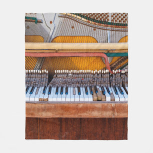 Old vintage piano with the lid off. A dilapidated Fleece Blanket