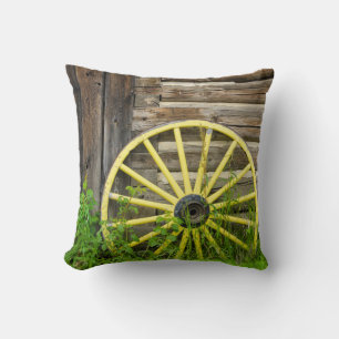Old wagon wheel in historic old gold town cushion