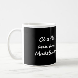 One side of the mug says Cò a th' ann am Madeline?