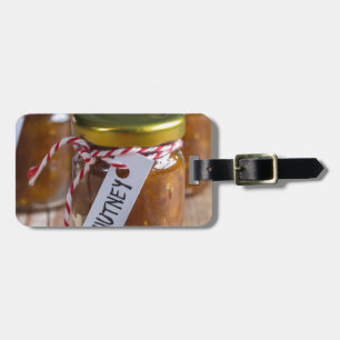 Onion pineapple chutney on rustic wood luggage tag