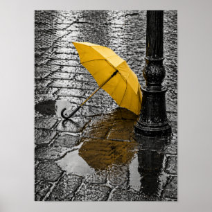 Open Yellow Umbrella on Rainy Cobblestone Street Poster