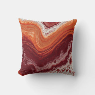 orange and burgundi fluid cushion