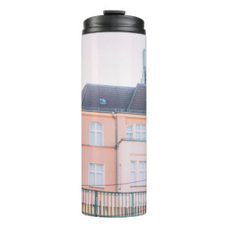 ORANGE AND WHITE CONCRETE BUILDING THERMAL TUMBLER