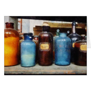 Orange, Brown and Blue Bottles of Chemicals