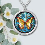 Orange Butterfly Blue Stained Glass Silver Plated Necklace<br><div class="desc">On this unique necklace is the image of a beautiful orange and gold butterfly against a stained glass style background. The background and border are in tones of blue. Elegant,  bright,  and colourful! Be sure to see the matching earrings and key chain in our store.</div>