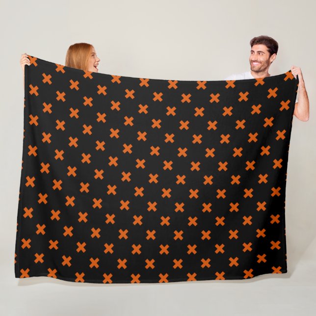 Orange cross stitches on black fleece blanket (In Situ)