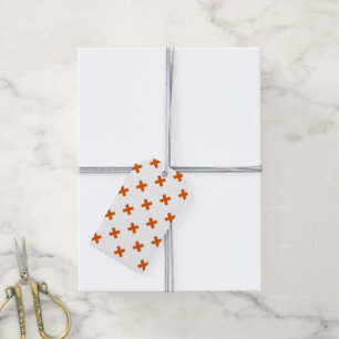 Orange cross stitches on white gift tags