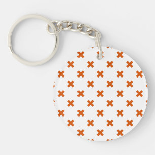 Orange cross stitches on white key ring