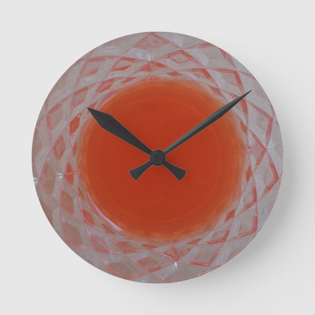 Orange drink inside a crystal glass round clock (Front)