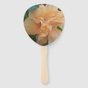 Orange hibiscus flower on a handheld fan
