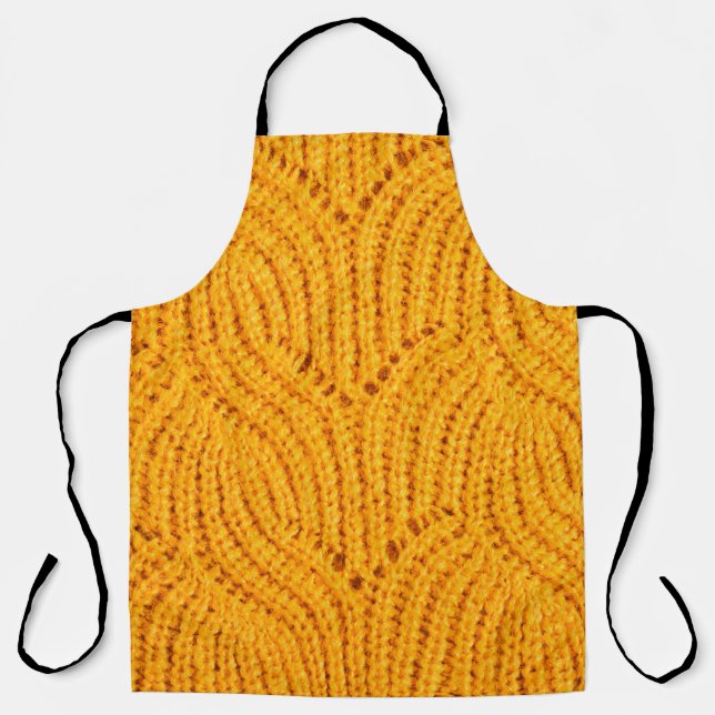 Orange knitted sweater, textured background. apron (Front)