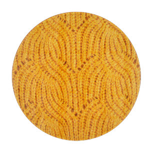 Orange knitted sweater, textured background. cutting board
