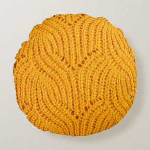 Orange knitted sweater, textured background. round cushion