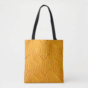 Orange knitted sweater, textured background. tote bag