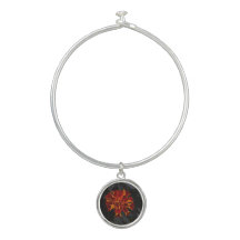 orange marigold charm on women's bracelt