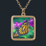 Orange monarch butterfly photo purple flower bold gold plated necklace<br><div class="desc">A close-up photo of a delicate, orange and black monarch butterfly resting on a bright magenta flower. Explore thoughts of warm, sunny days whenever you wear this stunning, colourful photography charm necklace. This necklace comes in small, medium and large sizes, as well as both square and circle shapes. You can...</div>