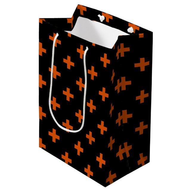 Orange polka crosses on black medium gift bag (Front Angled)