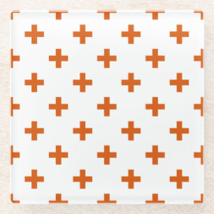 Orange polka crosses on white glass coaster