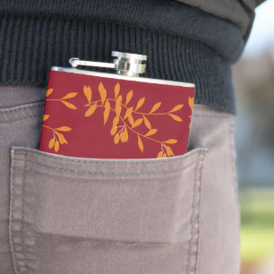 Orange silhouette branch leaves on red hip flask