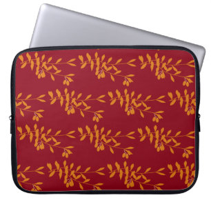 Orange silhouette branch leaves on red laptop sleeve