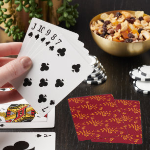 Orange silhouette branch leaves on red playing cards