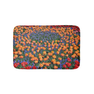 Orange tulips and muscari flowers bath mat