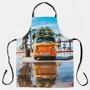 Orange van with surfboard on top apron