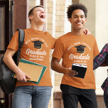 Orange White Graduate Custom Graduation T-Shirt<br><div class="desc">This orange custom senior graduate t-shirt features classy white typography of your high school or college name for the class of 2025. Customise with your graduating year under the chic white handwritten script and black grad cap for a great personalised graduation tee for a party or keepsake gift for your...</div>