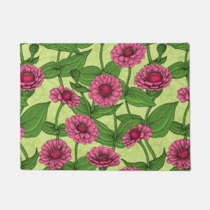 Orange Zinnia flowers, green leaves on dark green Doormat