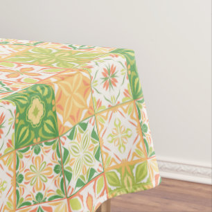 Ornate tiles in green and yellow tablecloth