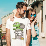 Oscar the Grouch Scram Tri-Blend Shirt<br><div class="desc">Showcase your love for Oscar the Grouch with this "Scram!" T-Shirt featuring the iconic Sesame Street character. The design highlights Oscar’s grumpy charm with bold text and his famous expression,  making it a fun and playful choice for fans of all ages.</div>