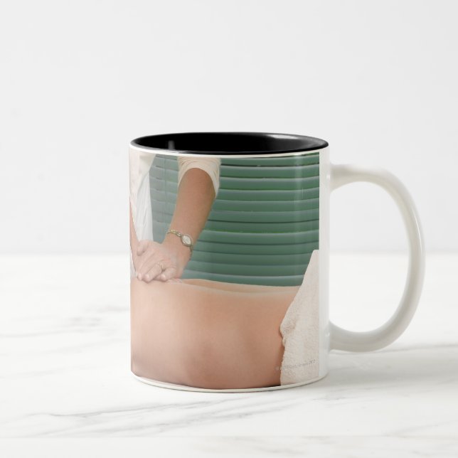 Osteopath/chiropractor manipulating back Two-Tone coffee mug (Right)