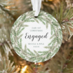 Our First Christmas Engaged Pine Wreath Photo Ornament<br><div class="desc">Simple keepsake acrylic ornament featuring a rustic watercolor painted pine greenery wreath with "Our First Christmas Engaged" along with your names and the year in green. The backside has your favourite engagement photo. This custom holiday ornament makes a great gift for a newly engaged couple. Coordinating items available in the...</div>