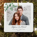 Our First Christmas Photo Ceramic Ornament<br><div class="desc">This First Christmas Photo Ornament is decorated with watercolor mistletoe and stylish script typography. Easily customisable with your photo, name, and year. Use the Design Tool to change the text size, style, or colour. Because we create our artwork you won't find this exact image from other designers. Original Watercolor ©...</div>