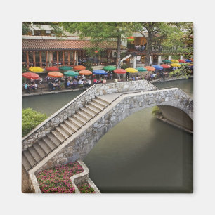 Outdoor cafe along River Walk and bridge over 2 Magnet