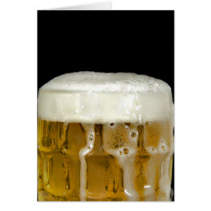 overflowing beer mug on black