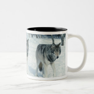 Pack of wolves at edge of snowy forest Two-Tone coffee mug