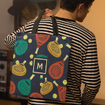 Padel Rackets Pattern with Initial Tote Bag<br><div class="desc">This tote bag is ready to be customised with your choice of initial and features a pattern of padel tennis rackets and balls in shades of terra cotta,  gold,  teal,  yellow and cream against a navy blue background.</div>