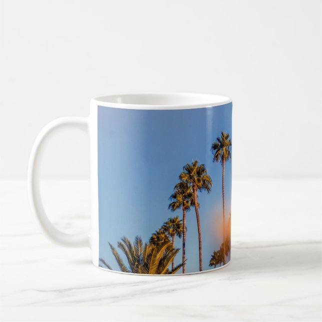 Palm tree under blue sky coffee mug (Left)