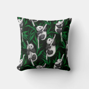 Panda cubs on dark green cushion