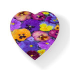 Pansy flowers floating in bird bath with dew